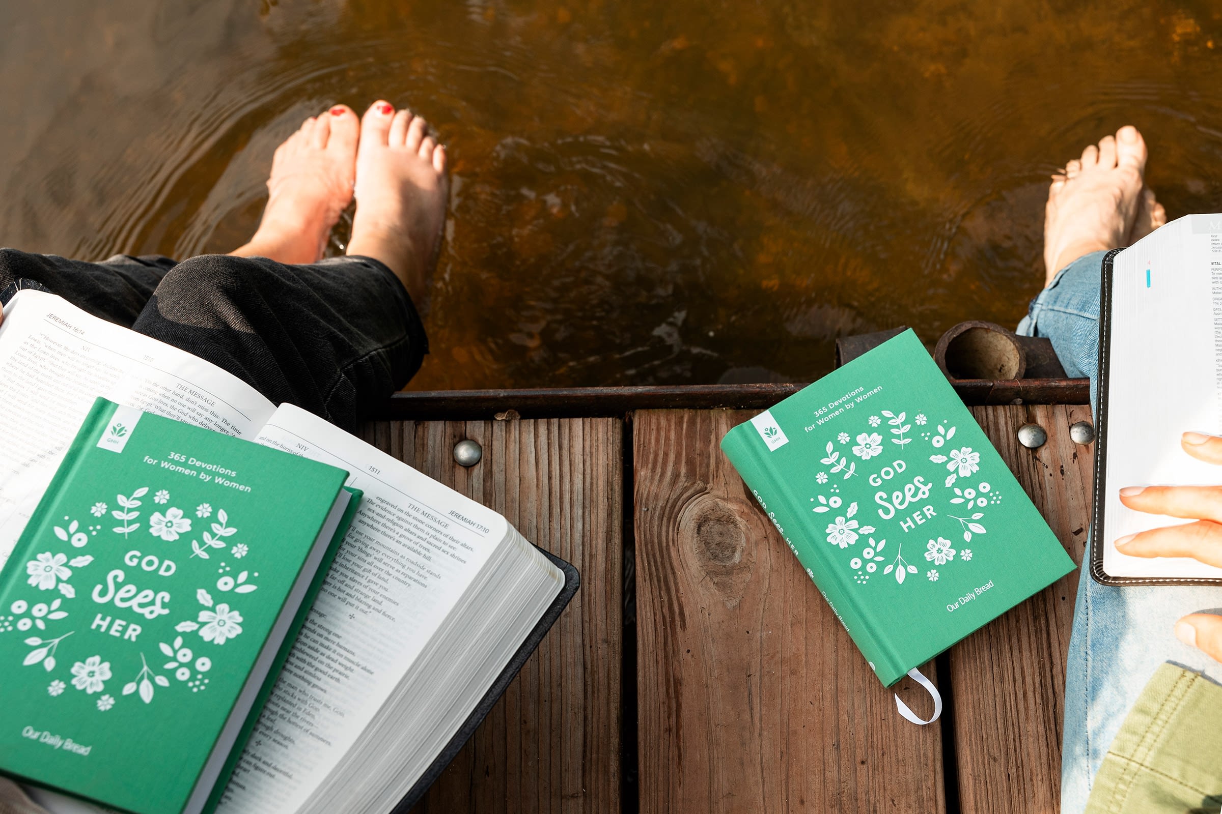 Reading books by the water, feet in river