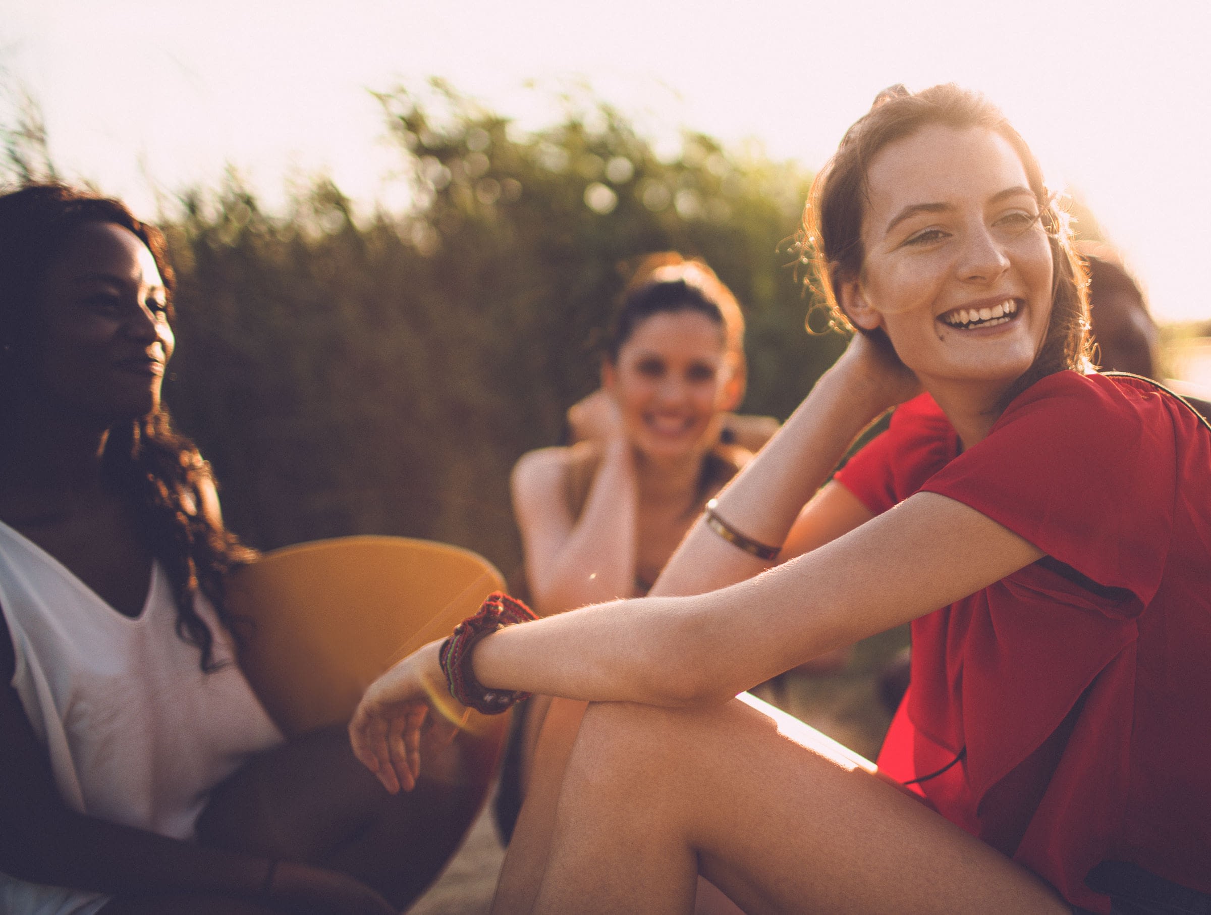 A group of women hanging out and smiling