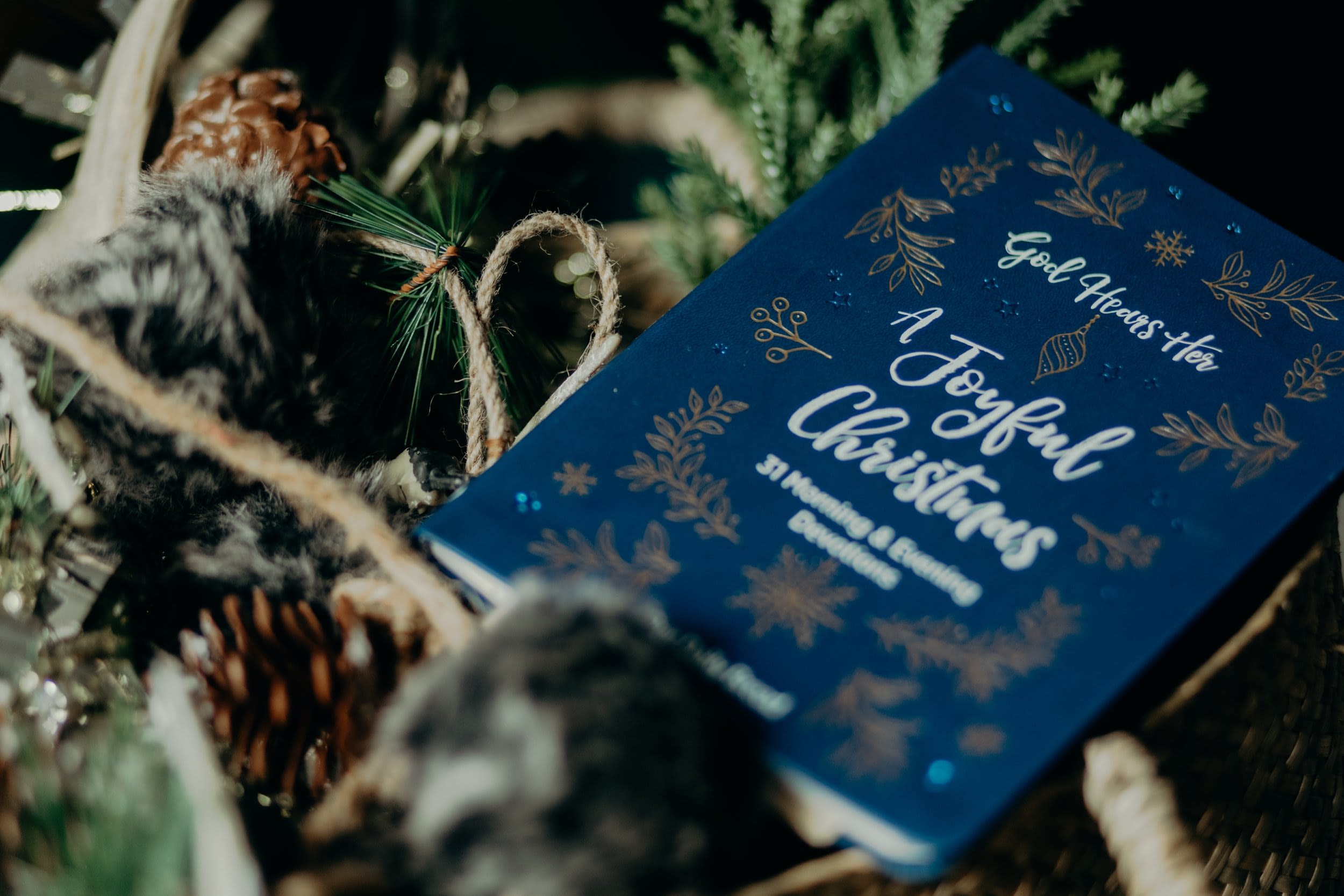 A Joyful Christmas book with festive decorations.