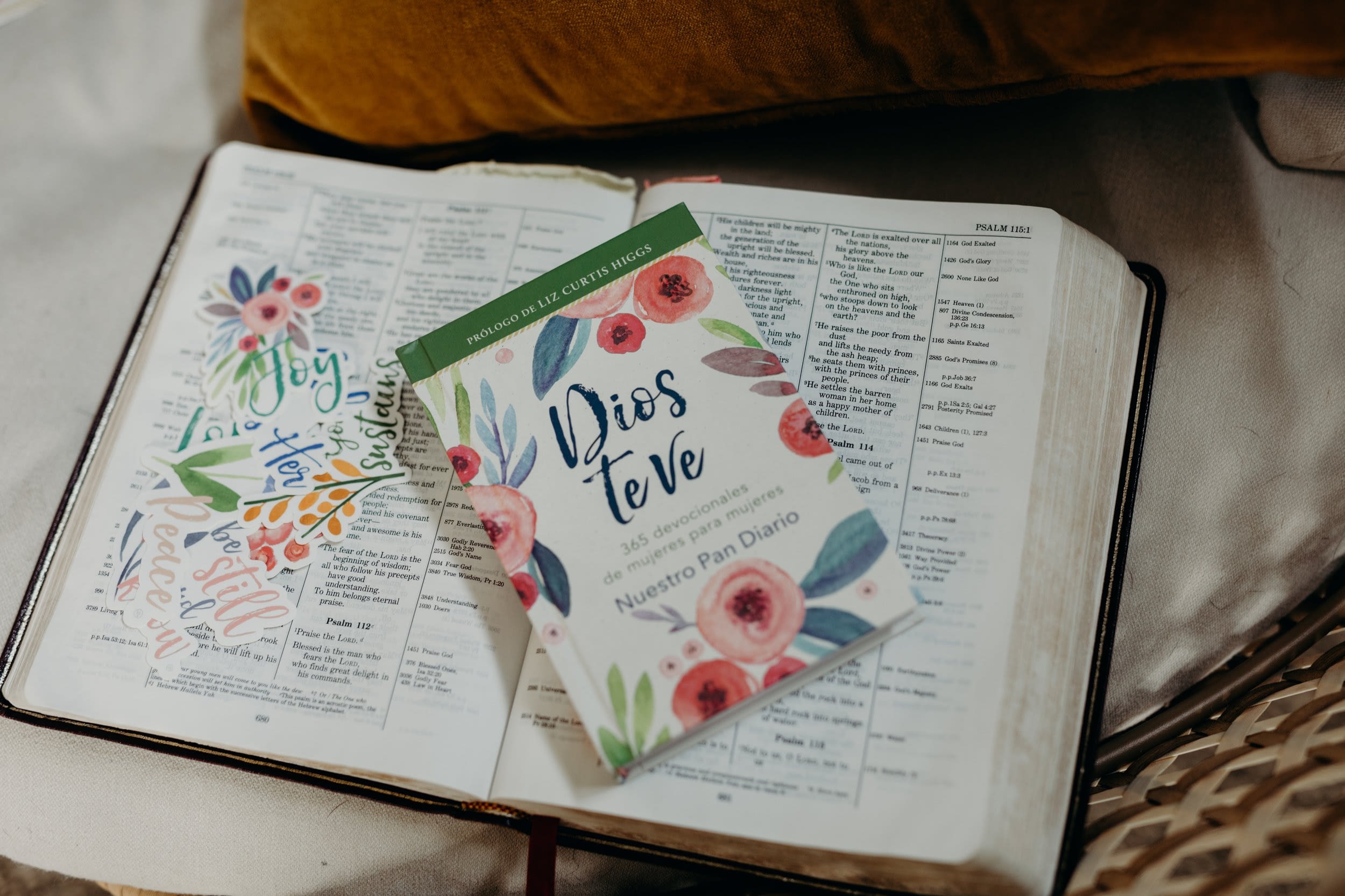 Devotional book on an open Bible with stickers.