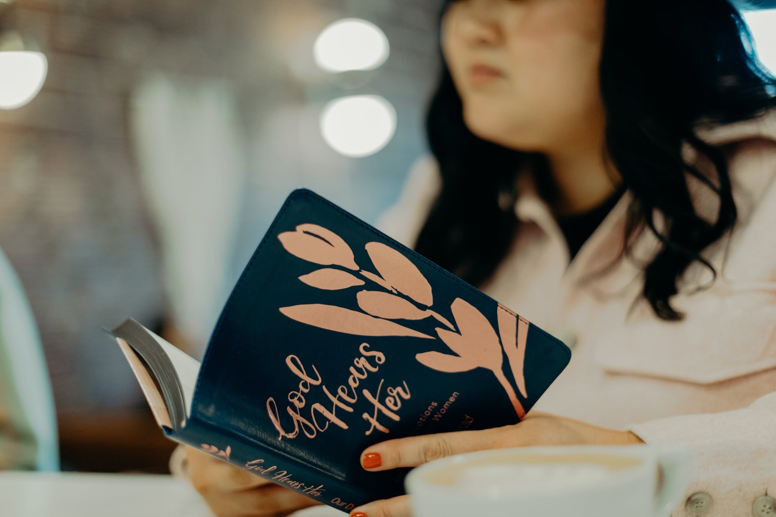 Woman reading God Hears Her book